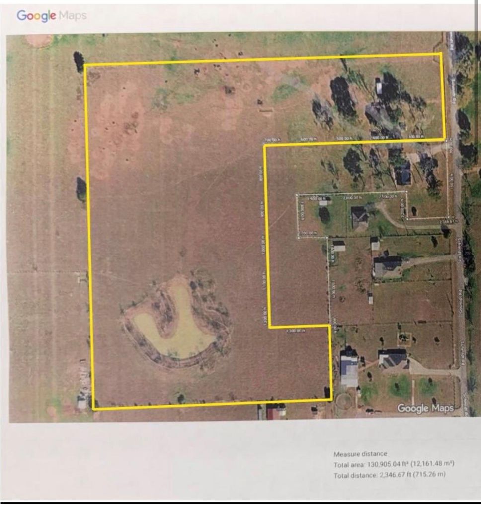 Aerial map of the property outlined in yellow over satellite imagery, showing the U-shaped pond and the two combined parcels along Schmidt Road